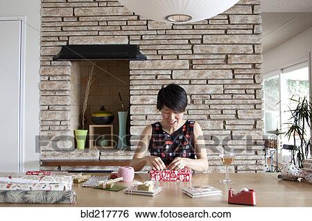 Stock Photograph - Japanese woman wrapping gifts. Fotosearch