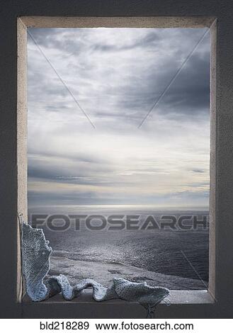 Knitted scarf in window over seascape View Large Photo Image Stock Photo - Knitted scarf in window over seascape. Fotosearch