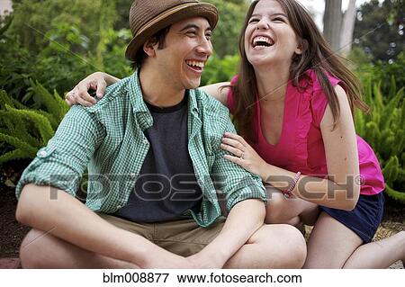 Laughing couple enjoying the outdoors View Large Photo Image Stock Photo - Laughing couple enjoying the outdoors. Fotosearch