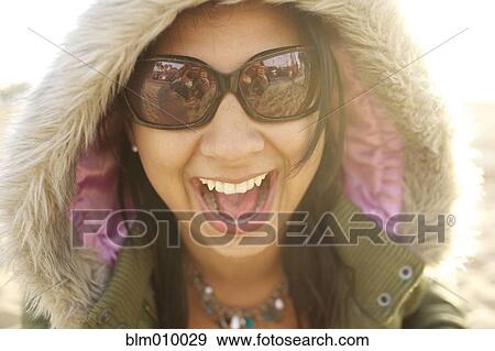 Laughing mixed race woman in fur hood View Large Photo Image Stock Photo - Laughing mixed race woman in fur hood. Fotosearch