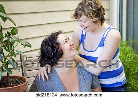 Lesbian couple relaxing in backyard View Large Photo Image Picture - Lesbian couple relaxing in backyard. Fotosearch