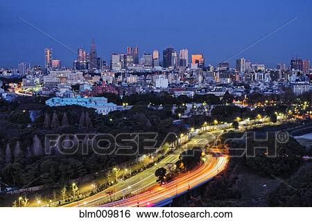 Long exposure of urban highway and cityscape at night View Large Photo Image Stock Photograph - Long exposure of urban highway and cityscape at night. Fotosearch