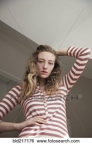 Low angle view of woman posing under gray sky View Large Photo Image Stock Photograph - Low angle view of woman posing under gray sky. Fotosearch