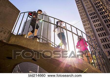 Low angle view of women running on urban staircase View Large Photo Image Stock Image - Low angle view of women running on urban staircase. Fotosearch