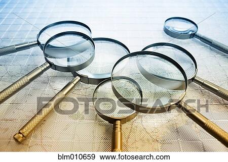Magnifying glasses laying on map View Large Photo Image Stock Photo - Magnifying glasses laying on map. Fotosearch
