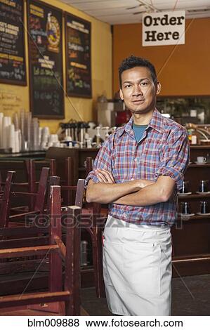 Malaysian cafe owner standing with arms crossed View Large Photo Image Stock Photo - Malaysian cafe owner standing with arms crossed. Fotosearch