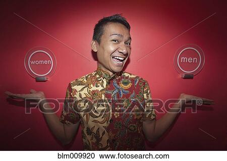 Malaysian man gesturing toward men and women signs View Large Photo Image Stock Image - Malaysian man gesturing toward men and women signs. Fotosearch