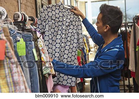 Malaysian man shopping in vintage store View Large Photo Image Stock Image - Malaysian man shopping in vintage store. Fotosearch