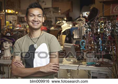 Malaysian man working in vintage store View Large Photo Image Stock Photograph - Malaysian man working in vintage store. Fotosearch