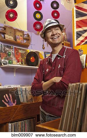 Stock Photo - Malaysian owner in record store. Fotosearch