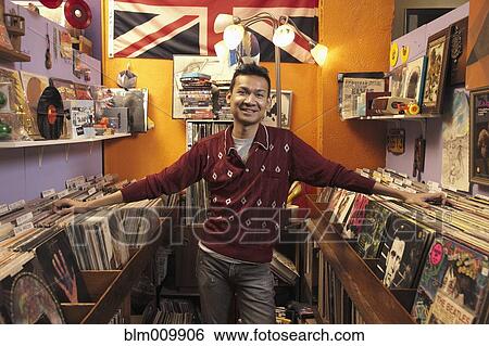 Stock Photograph - Malaysian owner in record store. Fotosearch