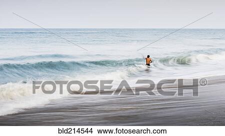 Picture - Man swimming in waves. Fotosearch