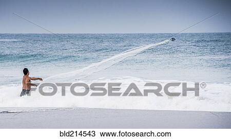 Man watching boat in ocean waves from beach View Large Photo Image Stock Image - Man watching boat in ocean waves from beach. Fotosearch