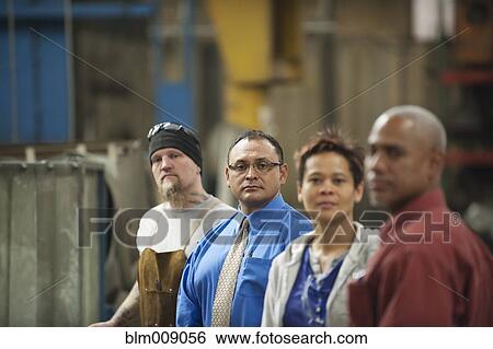 Manager and workers standing in factory View Large Photo Image Stock Photograph - Manager and workers standing in factory. Fotosearch