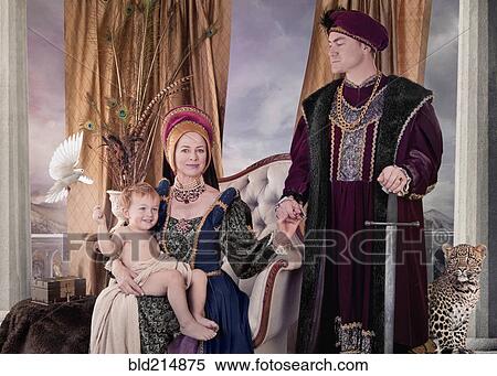 Stock Photography - Medieval couple and child posing in living room. Fotosearch