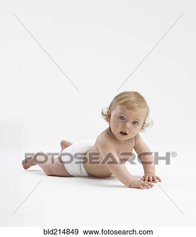 Stock Photo - Mixed race baby girl crawling on floor. Fotosearch
