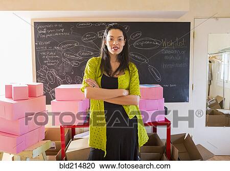 Mixed race businesswoman standing in office View Large Photo Image Stock Image - Mixed race businesswoman standing in office. Fotosearch