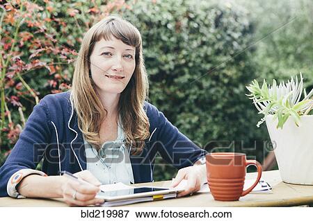 Mixed race businesswoman using digital tablet in backyard View Large Photo Image Stock Photo - Mixed race businesswoman using digital tablet in backyard. Fotosearch