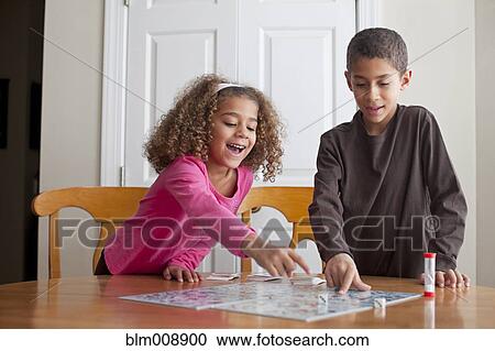 Mixed race children playing board game together View Large Photo Image Stock Image - Mixed race children playing board game together. Fotosearch