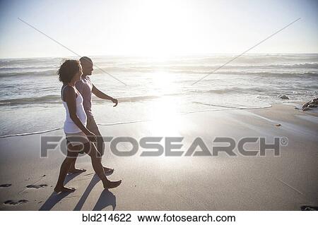 Mixed race couple walking on beach View Large Photo Image Stock Image - Mixed race couple walking on beach. Fotosearch