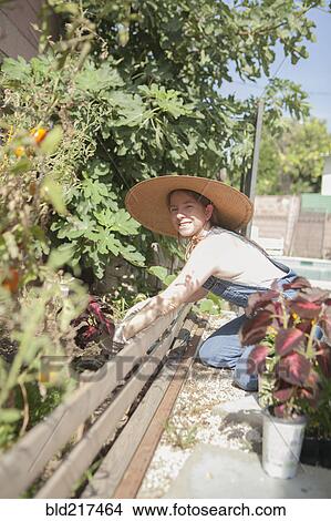 Picture - Mixed race farmer working in garden. Fotosearch