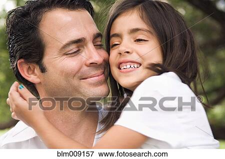 Mixed race father hugging daughter View Large Photo Image Stock Photo - Mixed race father hugging daughter. Fotosearch