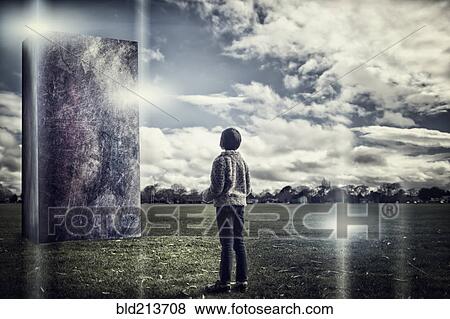 Stock Photo - Mixed race girl admiring stone sculpture in field. Fotosearch