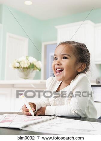 Mixed race girl drawing in notebook View Large Photo Image Stock Photo - Mixed race girl drawing in notebook. Fotosearch