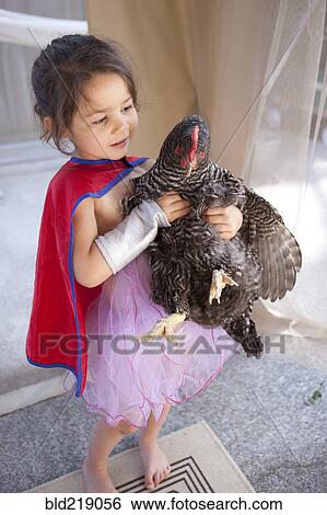 Mixed race girl holding chicken View Large Photo Image Stock Photograph - Mixed race girl holding chicken. Fotosearch
