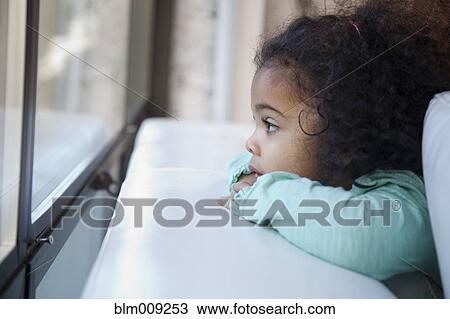 Mixed race girl looking out window View Large Photo Image Stock Image - Mixed race girl looking out window. Fotosearch