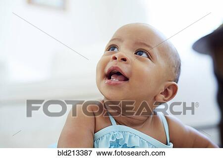 Mixed race girl looking up View Large Photo Image Stock Photo - Mixed race girl looking up. Fotosearch