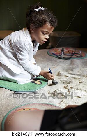 Mixed race girl painting on fabric View Large Photo Image Stock Image - Mixed race girl painting on fabric. Fotosearch