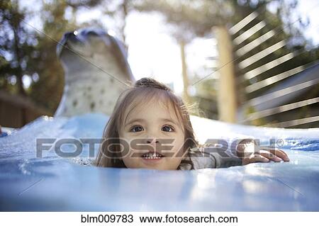 Mixed race girl playing at zoo View Large Photo Image Stock Image - Mixed race girl playing at zoo. Fotosearch