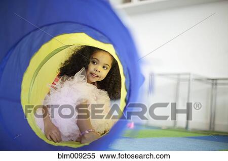 Mixed race girl playing in tube View Large Photo Image Stock Photography - Mixed race girl playing in tube. Fotosearch