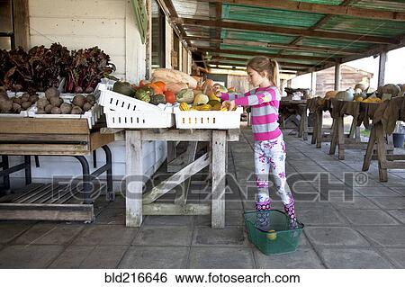 Stock Photograph - Mixed race girl shopping in farmers market. Fotosearch
