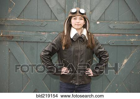 Picture - Mixed race girl wearing aviator goggles. Fotosearch