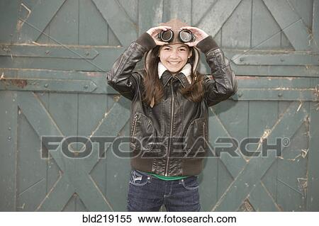 Mixed race girl wearing aviator goggles View Large Photo Image Stock Photography - Mixed race girl wearing aviator goggles. Fotosearch
