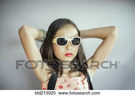 Stock Photography - Mixed race girl wearing makeup and sunglasses. Fotosearch