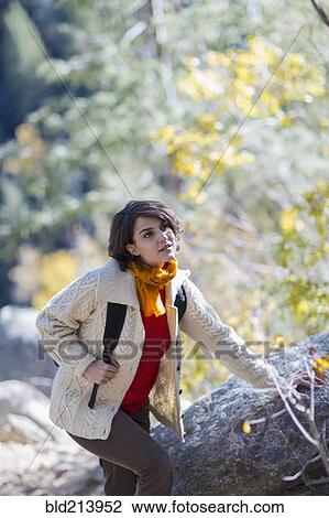 Stock Image - Mixed race hiker exploring forest. Fotosearch