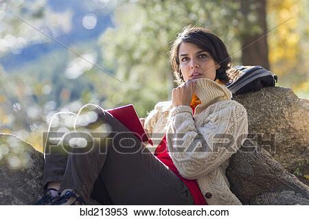 Mixed race hiker reading in forest View Large Photo Image Stock Image - Mixed race hiker reading in forest. Fotosearch