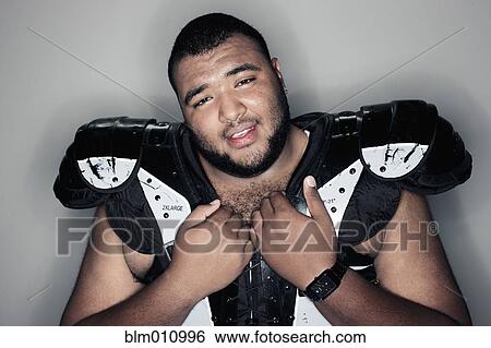 Mixed race man in football shoulder pads View Large Photo Image Stock Photograph - Mixed race man in football shoulder pads. Fotosearch