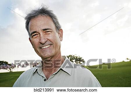 Stock Image - Mixed race man smiling outdoors. Fotosearch