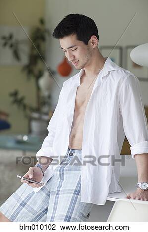 Mixed race man text messaging on cell phone View Large Photo Image Stock Image - Mixed race man text messaging on cell phone. Fotosearch
