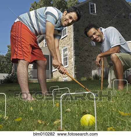 Mixed race men playing croquet View Large Photo Image Stock Image - Mixed race men playing croquet. Fotosearch