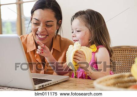 Mixed race mother and daughter using laptop View Large Photo Image Stock Photography - Mixed race mother and daughter using laptop. Fotosearch
