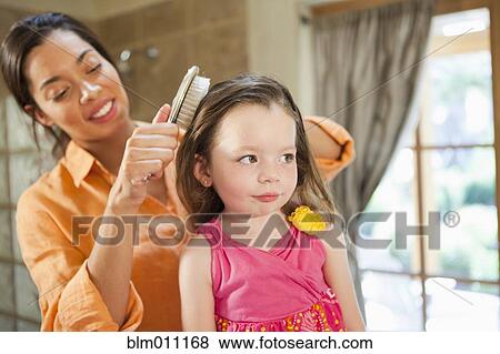 Mixed race mother brushing daughter's hair View Large Photo Image Stock Photo - Mixed race mother brushing daughter's hair. Fotosearch