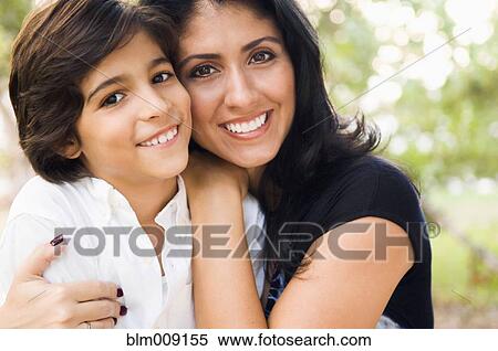 Stock Photography - Mixed race mother hugging son. Fotosearch