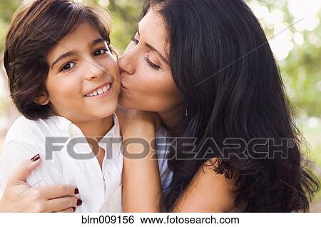 Mixed race mother kissing son View Large Photo Image Stock Photograph - Mixed race mother kissing son. Fotosearch