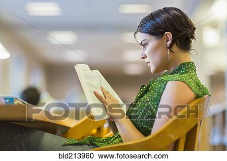 Stock Image - Mixed race student studying in library. Fotosearch
