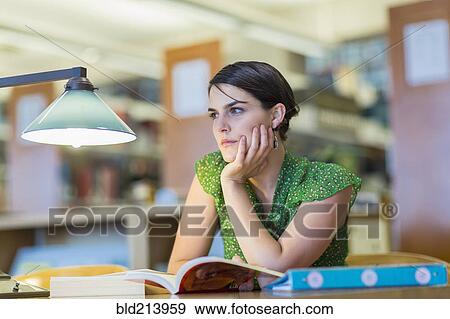 Stock Photo - Mixed race student studying in library. Fotosearch